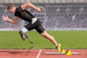 Disabled sprinter with prosthetic leg at start block
